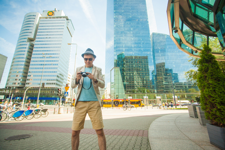Man makes photo shoot of skyscrapers in the big city. Travel and lifestyle concept.の写真素材