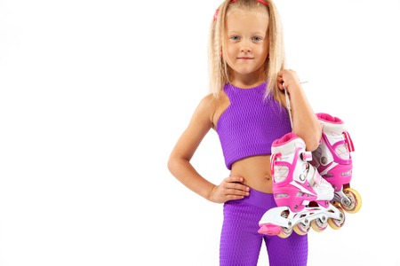 Girl, kid posing in studio wearing inline rollerskatesの写真素材