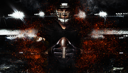 American football player, athlete in helmet with ball on black background. Sport wallpaper with copyspace.の写真素材