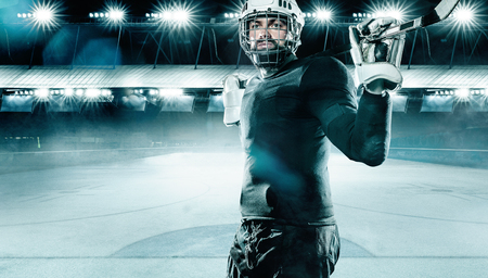 Ice Hockey player athlete in the helmet and gloves on stadium with stick. Action shot. Sport concept.の写真素材