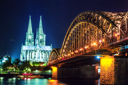 Cologne Cathedral and Hohenzollern Bridge at sunset, nighttime. Photo for postcardの写真素材