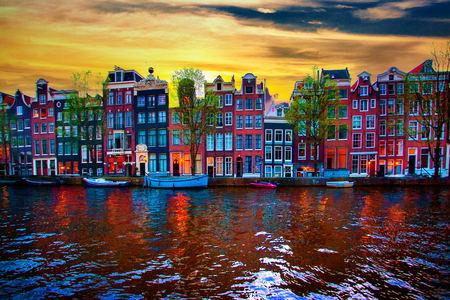 Amsterdam canal with typical dutch houses on sunrise, Holland, Netherlands.の写真素材