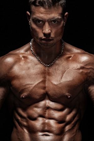 Bodybuilding competitions on the scene. Man sportsmen physique and athlete. Black background.の写真素材