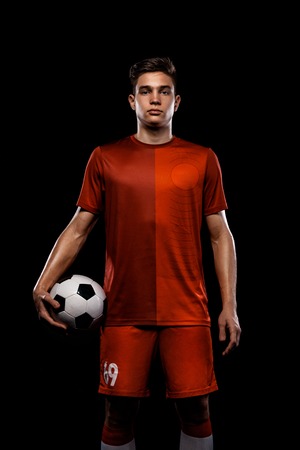 Teenager - soccer player. Boy in football sportswear after game with ball. Sport concept.の写真素材