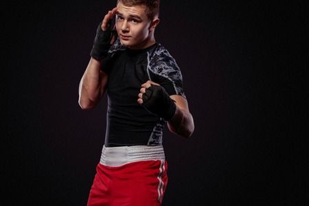 Sportsman, man boxer fighting in gloves. on black backgroundの写真素材