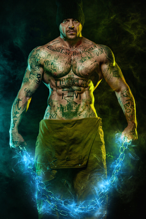 Muscular fitness sports man, atlete with chains in fitness gym. Energy and power.の写真素材