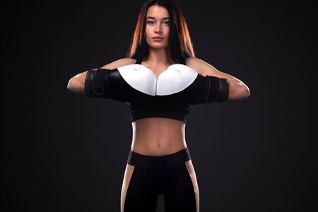 Woman boxer on black background. Boxing and fitness concept.