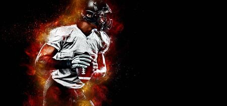 American football player. Sportsman with ball in helmet on stadium in action. Sport wallpaper. Team sports.の写真素材
