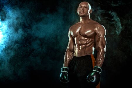 Sportsman, man boxer fighting in gloves on black background. Fitness and boxing concept. Individual sports recreation.の写真素材