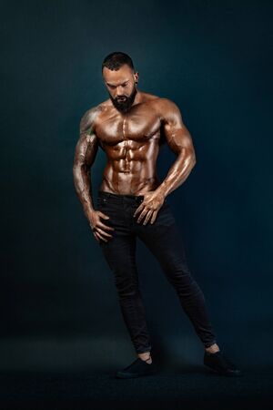 Strong and fit man bodybuilder. Sporty muscular guy athlete. Sport and fitness concept. Mens fashion.の写真素材