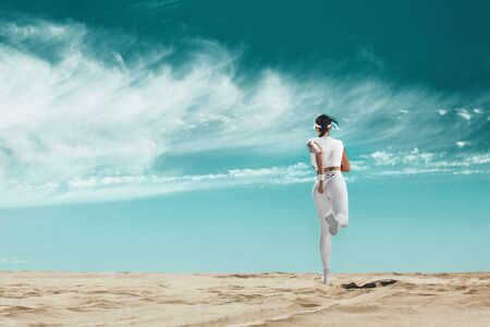 Sprinter, athlete runner. Sporty young and fit woman running on the sky background. The concept of a healthy lifestyle and sport. Woman in white sportswear.の写真素材