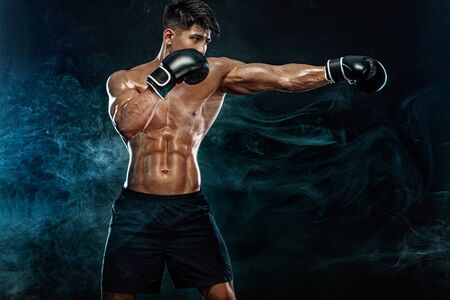 Street fighter fighting in boxing gloves. Isolated on black background with copy Space. Action shot. Sport concept.の写真素材