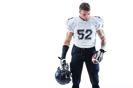 American football player. Sportsman with ball in helmet on stadium in action. Sport wallpaper. Team sports.の写真素材