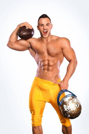 Gay streptizer with naked torso. American football player in helmet isolated on white background.の写真素材