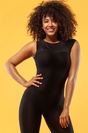 Lifestyle Concept. Portrait of beautiful happy and dancing African American woman with curly hair....