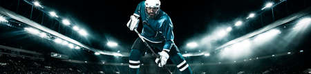 Ice Hockey player athlete in the helmet and gloves on stadium with stick. Action shot. Sport concept. Wide photo.の写真素材