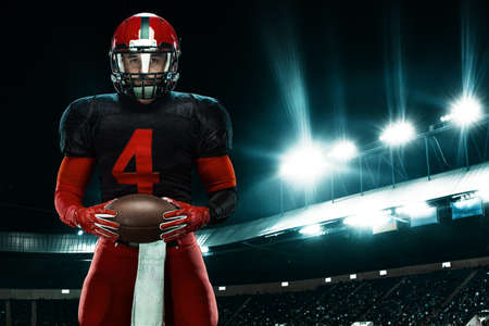 American football player, athlete sportsman in red helmet on stadium background. Sport and...