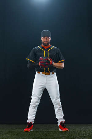 Baseball player on dark background. Ballplayer portrait.の写真素材