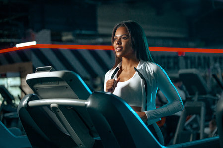 Athlete runner and sprinter, running on treadmill wearing in the sportswear. Fitness and sport motivation.の写真素材