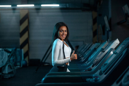Athlete runner and sprinter, running on treadmill wearing in the sportswear. Fitness and sport...