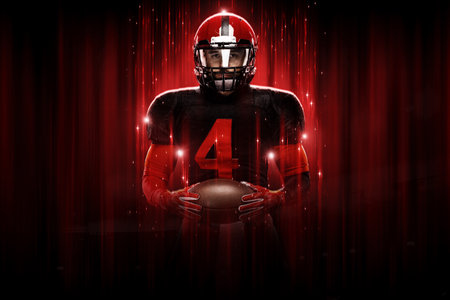American football player, athlete sportsman in red helmet on black background. Sport poster. Motivation wallpaper.の写真素材