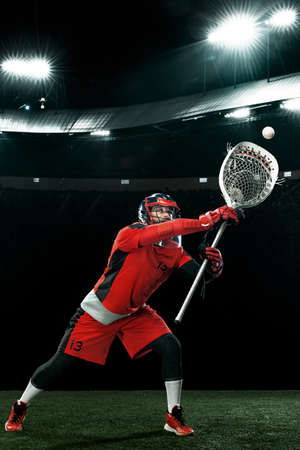 Lacrosse Player, athlete sportsman in red helmet on stadium background. Sport and motivation...