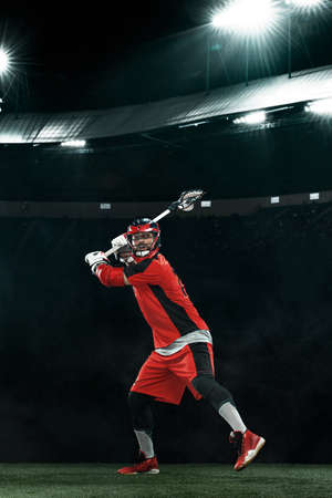 Lacrosse Player, athlete sportsman in red helmet on stadium background. Sport and motivation wallpaper.の写真素材