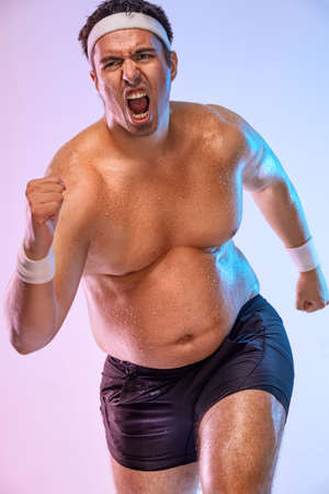 A very fat man jogging to lose weight and become a slim athlete. Running sport man.の写真素材