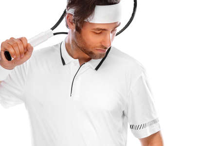 Tennis player with racket in white costume. Man athlete playing isolated on light background.の写真素材