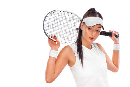 Tennis player with racket in white costume. Woman athlete playing isolated on white background.の写真素材