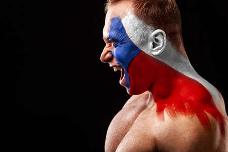 Czech Republic fan. Soccer or football athlete with flag bodyart on face. Sport concept with copyspace.の写真素材