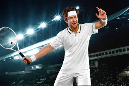 Tennis player with racket in white t-shirt. Man athlete playing on grand arena with tennis courts.の写真素材