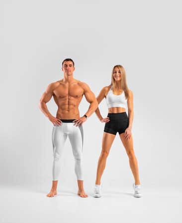 Fit couple at the gym isolated on white background. Fitness concept. Healthy life style.の写真素材