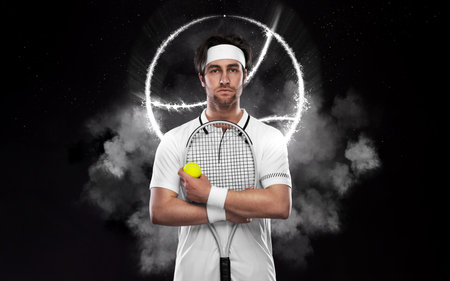 Tennis player with racket in white costume. Man athlete on the grand arena with tennis courts.の写真素材