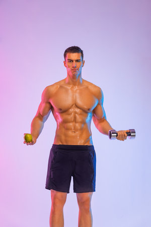 Happy man athlete with dumbbell isolated on pink background. Gym full body workout. Muscular man athlete in fitness gym have havy workout. Sports trainer on trainging. Fitness motivation.の写真素材