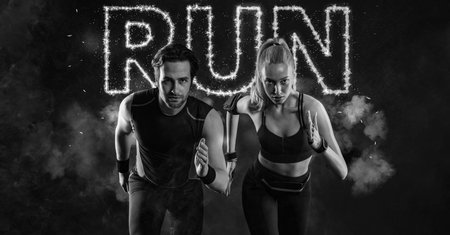 Sprinter run. Strong athletic woman and man running on black background wearing in the sportswear. Fitness and sport motivation. Runner concept.の写真素材