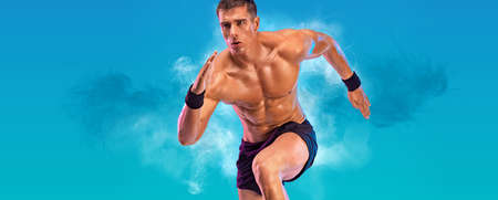 Runner concept. Athlete sprinter running on blue background. Fitness and sport motivation. Trail run.の写真素材