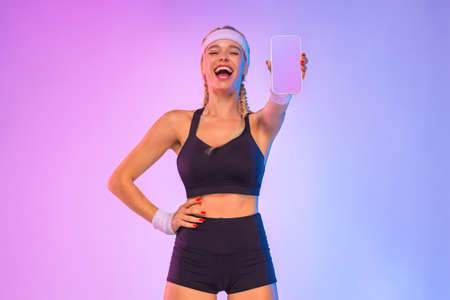 Design For Mobile Application. Dietetics And Fitness. Happy Woman With Smartphone. Blank Black Screen. Lady Recommending Application Or Fitness Website, Standing On pink Backgroundの写真素材