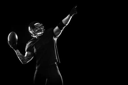 Sport concept. American football sportsman player on black background. Sport concept.の写真素材
