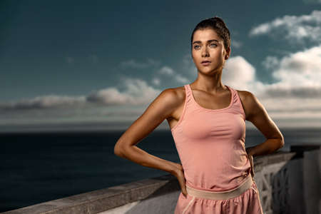 Fitness girl rest after practicing yoga or running outdoors. Fitness concept.の写真素材