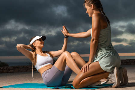 How to get abs. Females exercise for abdominal muscles. The girl does a fitness exercise for the...