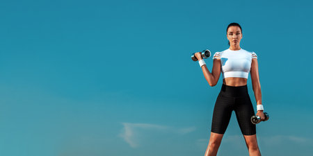Banner picture for fitness website. Fit woman works on weight loss and fat burning outdoors.の写真素材