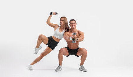 Fit couple at the gym isolated on white background. Fitness concept. Healthy life style. Fitness-Related Materials for Your Social Media Marketing Campaignsの写真素材