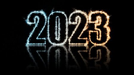 Happy New Year 2023. Burning sparkling text 2023 isolated on black background. Beautiful Glowing design element for greeting card and holiday flyerの写真素材