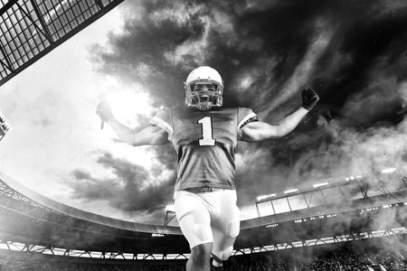 American football player celebrating victory on stadium . Template for a sports magazine on the...