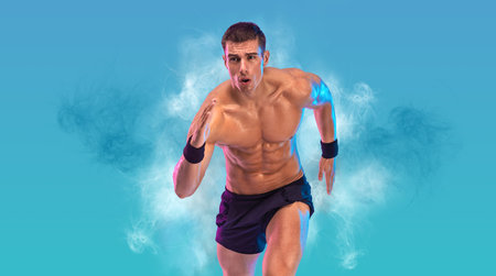 Runner concept. Athlete sprinter running on blue background. Fitness and sport motivation. Trail run. Picture for a sports article in a magazine or website.の写真素材