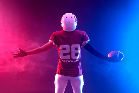 American football player teenager. Banner with neon colors. Template for bookmaker ads with copy space. Mockup for betting advertisement. Sports betting, football betting, gambling, bookmaker, big winの写真素材