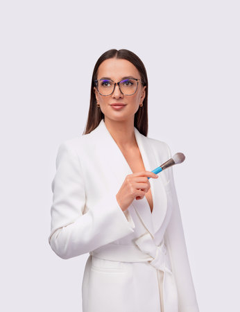 Makeup artist with beauty brush. Download an image to advertise your beauty salon or make-up studio. Picture with best salon advertising idea. Marketing Ideas for makeup artists.の写真素材