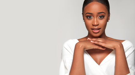Beautiful black skin african american girl. Emotional portrait of a surprised woman. I am listening to you. Copy space template for your promotion.の写真素材