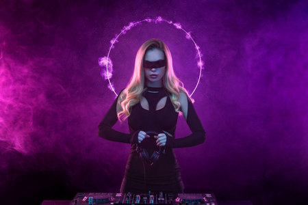 Music album cover design idea. Hot DJ in neon lights. Portrait of sexy TDJ at the night club party. Mixtape or book covers - download high resolution picture for your song or music clip.の写真素材